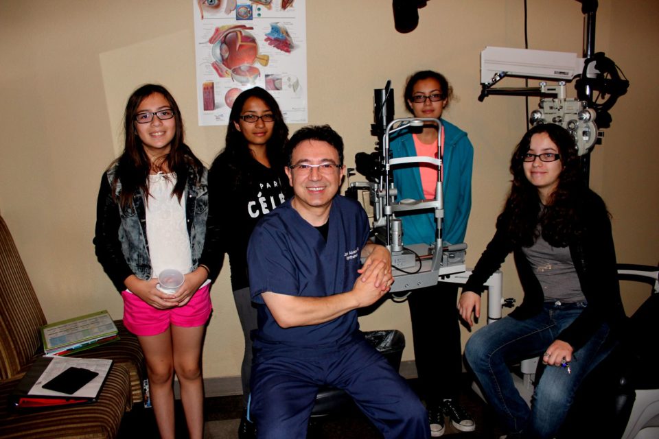 Dr. Jack Abrams hosted a free kids clinic giving free eye exams and glasses to kids in need like this family of four sisters who all wear glasses.